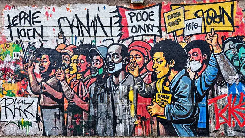 Mural vibrante de artistas pintando resistencia urbana